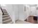 Modern staircase leading to the upper level, with a storage closet nearby at 1124 Spring Meadow Way, Wake Forest, NC 27587