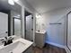 Modern bathroom with gray vanity, white sink and walk-in shower at 103 Calluna Dr, Clayton, NC 27520