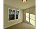 Well-lit bedroom featuring a large window and woodsy views at 97 Calluna Dr, Clayton, NC 27520