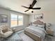 Virtually staged main bedroom with ceiling fan and large window at 97 Calluna Dr, Clayton, NC 27520