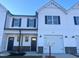White two-story townhome with a two-car garage and landscaping at 97 Calluna Dr, Clayton, NC 27520