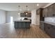 Modern kitchen with gray cabinets, granite countertops, and an island at 97 Calluna Dr, Clayton, NC 27520
