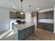 Modern kitchen with gray cabinets, granite countertops, and island at 97 Calluna Dr, Clayton, NC 27520