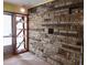 Stone accent wall and built-in shelving in entryway at 3007 Old Raleigh Rd, Apex, NC 27502