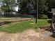 Backyard with chain link fence, retaining wall and grassy area at 3007 Old Raleigh Rd, Apex, NC 27502