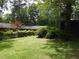 Spacious backyard with lush green grass and mature trees at 3007 Old Raleigh Rd, Apex, NC 27502
