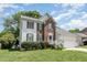 Two story brick and white sided home with attached garage at 2205 Moon Water Way, Garner, NC 27529