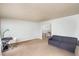 Living room with a gray couch and a workspace at 2205 Moon Water Way, Garner, NC 27529