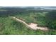 Aerial view showing a lot in a wooded area with lake access at 410 Firefly Overlook, Pittsboro, NC 27312