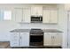 Bright kitchen with white cabinets, granite countertops and stainless steel appliances at 117 Ausban Rdg Ln # 034, Four Oaks, NC 27524