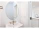 Modern powder room with oval mirror and updated vanity at 218 Sweetbay Tree Dr, Wendell, NC 27591