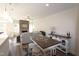 Open floor plan with kitchen island, living room with stone fireplace, and casual dining area at 1110 Talisker Way # 76, Burlington, NC 27215