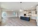 Open concept kitchen features a large island, stainless steel appliances, and white shaker cabinets at 2023 Seneca Dr # 32, Raleigh, NC 27604