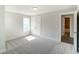 Bright bedroom with neutral carpeting, window, and private bathroom access at 2023 Seneca Dr # 32, Raleigh, NC 27604