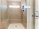 Walk-in shower with glass enclosure, built-in seat, and multiple shower heads at 2023 Seneca Dr # 32, Raleigh, NC 27604