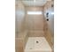 Walk-in shower with glass enclosure, built-in seat, and multiple shower heads at 2023 Seneca Dr # 32, Raleigh, NC 27604