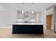Modern kitchen with large island and stainless steel appliances at 190 Whistlers Cv, Louisburg, NC 27549
