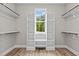 Walk-in closet with custom shelving and window at 190 Whistlers Cv, Louisburg, NC 27549