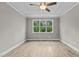 Spacious bedroom with wood-look flooring and a large window at 190 Whistlers Cv, Louisburg, NC 27549