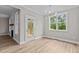 Bright breakfast nook with wood flooring and access to a deck at 190 Whistlers Cv, Louisburg, NC 27549