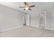 Bedroom with carpet, ceiling fan and access to bathroom and closet at 190 Whistlers Cv, Louisburg, NC 27549