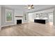 Open living room with fireplace and kitchen views at 190 Whistlers Cv, Louisburg, NC 27549