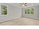 Bright bedroom with wood flooring, ceiling fan and large windows at 190 Whistlers Cv, Louisburg, NC 27549