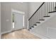 Front entry with a white door and hardwood flooring at 190 Whistlers Cv, Louisburg, NC 27549