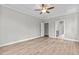 Bright bedroom featuring wood-look floors and ensuite bathroom access at 190 Whistlers Cv, Louisburg, NC 27549