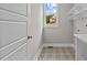 Laundry room with patterned tile flooring and built-in shelving at 190 Whistlers Cv, Louisburg, NC 27549