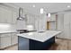 Modern kitchen with island, stainless steel appliances, and white shaker cabinets at 190 Whistlers Cv, Louisburg, NC 27549
