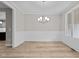 Bright dining room with hardwood floors and a modern chandelier at 190 Whistlers Cv, Louisburg, NC 27549