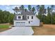 Rear view of house showing deck, garage and backyard at 190 Whistlers Cv, Louisburg, NC 27549