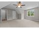 Bright bedroom with carpet, ceiling fan and window at 190 Whistlers Cv, Louisburg, NC 27549
