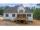 Rear view of house showcasing a large deck and screened porch at 190 Whistlers Cv, Louisburg, NC 27549