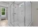 Large walk-in shower with marble tile and built-in bench at 190 Whistlers Cv, Louisburg, NC 27549