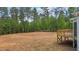 Large backyard with deck and surrounding trees at 190 Whistlers Cv, Louisburg, NC 27549