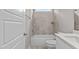 Bathroom with a shower/tub combo, white vanity, and neutral tile at 190 Whistlers Cv, Louisburg, NC 27549