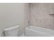 Bathroom with a toilet and bathtub shower combo at 190 Whistlers Cv, Louisburg, NC 27549