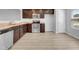 Modern kitchen with dark brown cabinets, stainless steel appliances, and light flooring at 3915 Swinton St, Raleigh, NC 27616