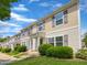 Townhome with beige siding, multiple windows, and manicured landscaping at 3915 Swinton St, Raleigh, NC 27616