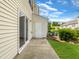 Concrete patio with exterior door and surrounding greenery at 3915 Swinton St, Raleigh, NC 27616