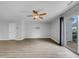 Spacious living room with ceiling fan and sliding door access to patio at 3915 Swinton St, Raleigh, NC 27616