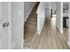 Light-filled entryway with stairs and wood-look flooring at 3915 Swinton St, Raleigh, NC 27616