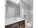 Clean bathroom with dark brown vanity, white toilet, and shower/tub combo at 3915 Swinton St, Raleigh, NC 27616
