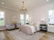 Spacious main bedroom with a large bed, sitting area, and plenty of natural light at 140 Pondhurst Ln, Fuquay Varina, NC 27526