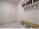 Functional laundry room with upper cabinets and built-in bench at 140 Pondhurst Ln, Fuquay Varina, NC 27526