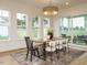 Bright dining room with a large table, hardwood floors, and access to a patio at 140 Pondhurst Ln, Fuquay Varina, NC 27526