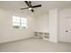 Bright bedroom with ceiling fan, built-in shelving and large window at 140 Pondhurst Ln, Fuquay Varina, NC 27526