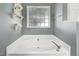 Bathroom features a large garden tub and a window at 221 Southerby Dr, Garner, NC 27529